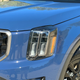 Close-up photo of the driver's side headlight on a 2023 Kia Telluride SX X-Pro painted blue.